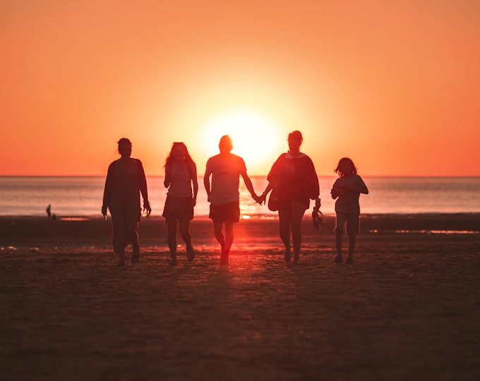 Friends on the beach at golden hour